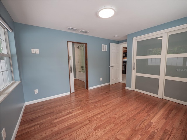 unfurnished room with light wood-type flooring