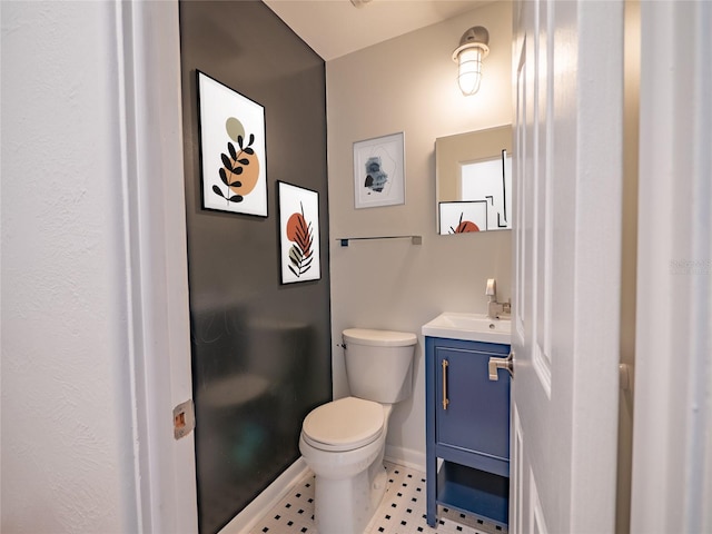 bathroom with tile patterned flooring, vanity, and toilet