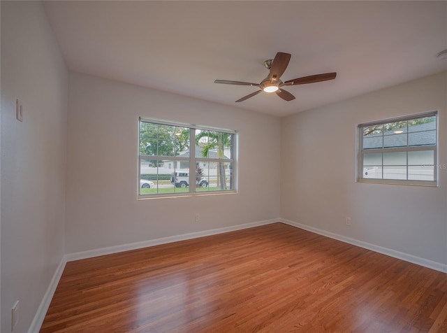 spare room with ceiling fan and light wood-type flooring