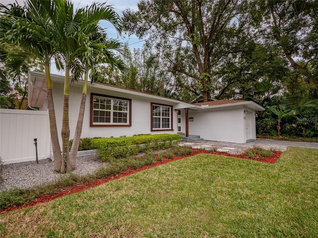 ranch-style home featuring a front yard and a garage