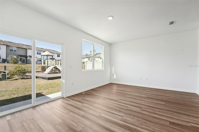 empty room with hardwood / wood-style flooring