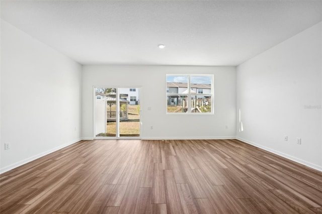 spare room with wood-type flooring