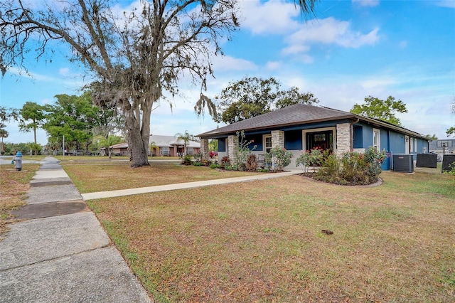 single story home featuring central AC unit and a front yard