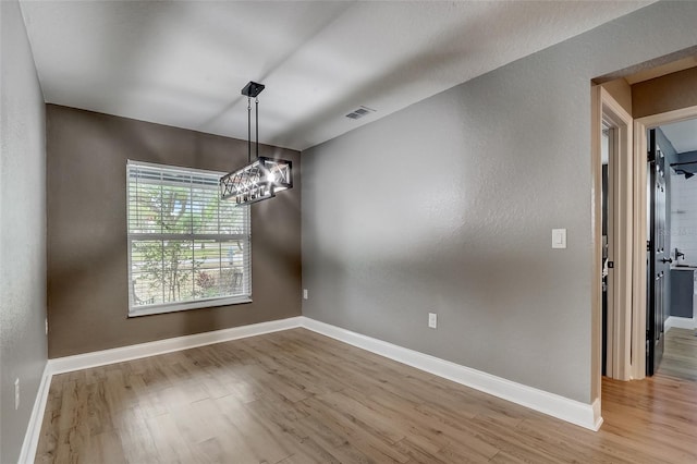 unfurnished dining area featuring hardwood / wood-style flooring