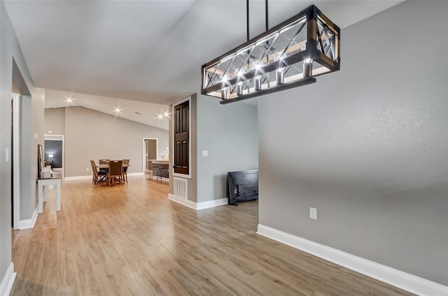 unfurnished dining area with hardwood / wood-style floors and lofted ceiling