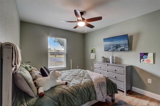 bedroom featuring ceiling fan and light hardwood / wood-style floors