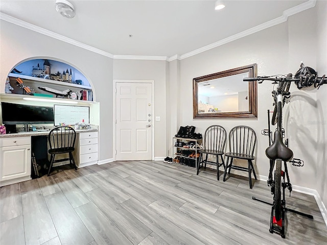 office space with ornamental molding and light wood-type flooring