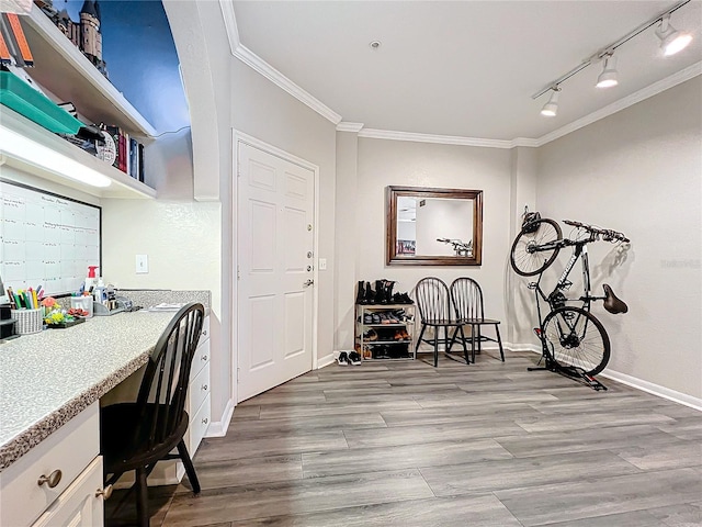 interior space featuring ornamental molding and light hardwood / wood-style flooring