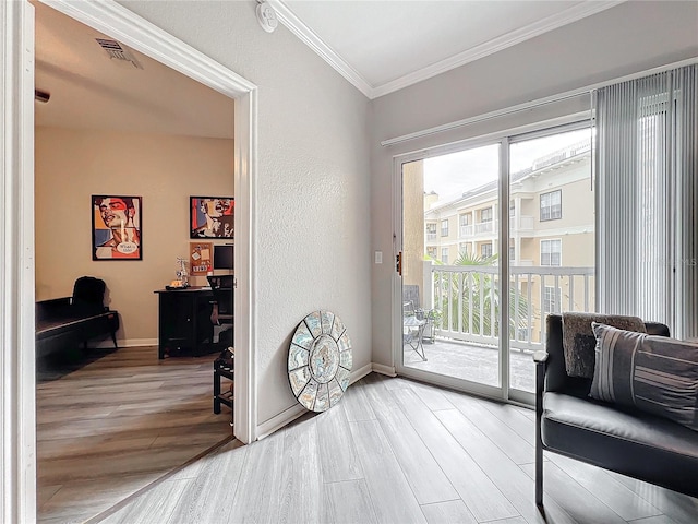 entryway featuring hardwood / wood-style flooring and ornamental molding