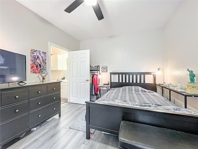 bedroom featuring light hardwood / wood-style flooring, ceiling fan, and ensuite bathroom