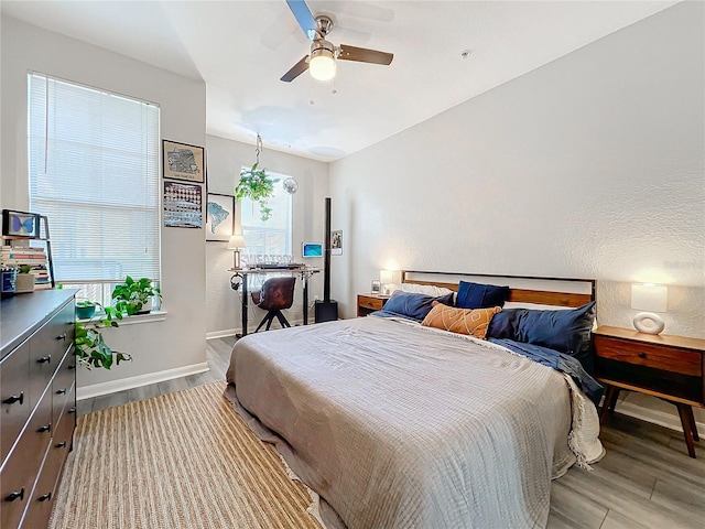 bedroom with ceiling fan and light hardwood / wood-style flooring