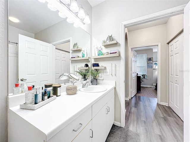 bathroom with hardwood / wood-style flooring and vanity