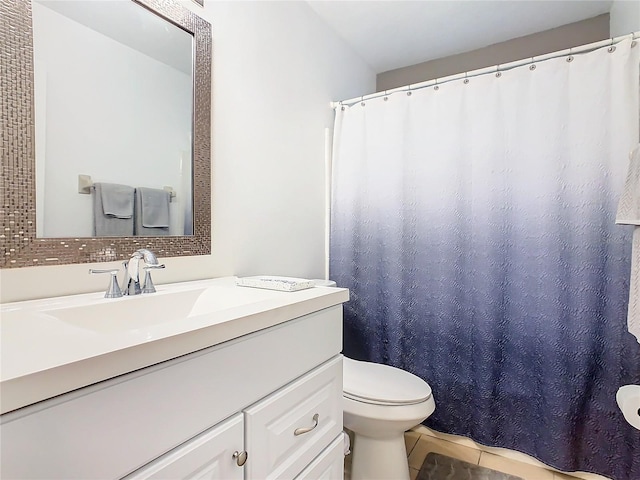 bathroom featuring backsplash, vanity, and toilet