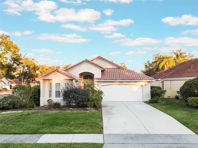 mediterranean / spanish-style home with a garage and a front yard