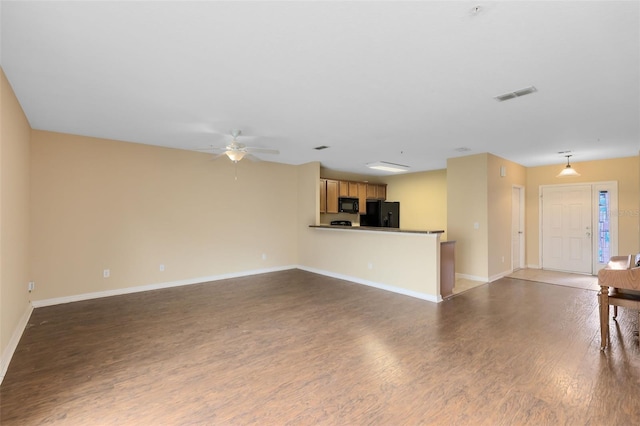 unfurnished living room with ceiling fan and dark hardwood / wood-style floors