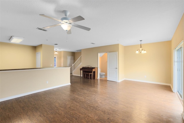 spare room with wood-type flooring and ceiling fan with notable chandelier