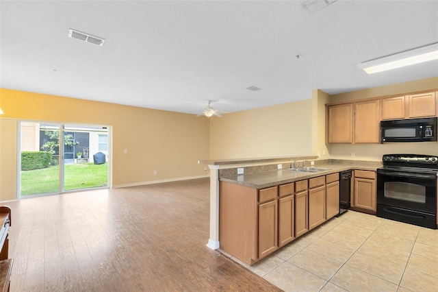 kitchen with black appliances, ceiling fan, kitchen peninsula, and sink