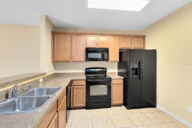 kitchen featuring black appliances, light tile patterned flooring, and sink