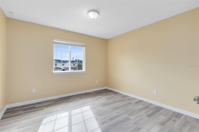 unfurnished room with light hardwood / wood-style flooring