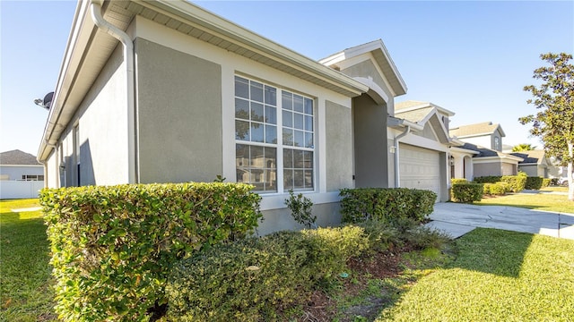 view of home's exterior featuring a lawn and a garage