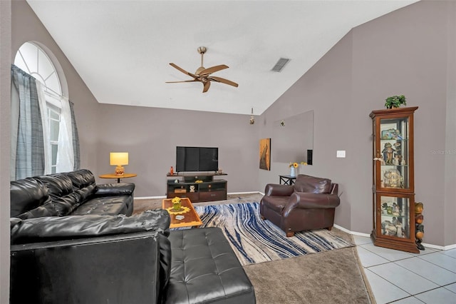 living room featuring ceiling fan, lofted ceiling, and light tile patterned flooring