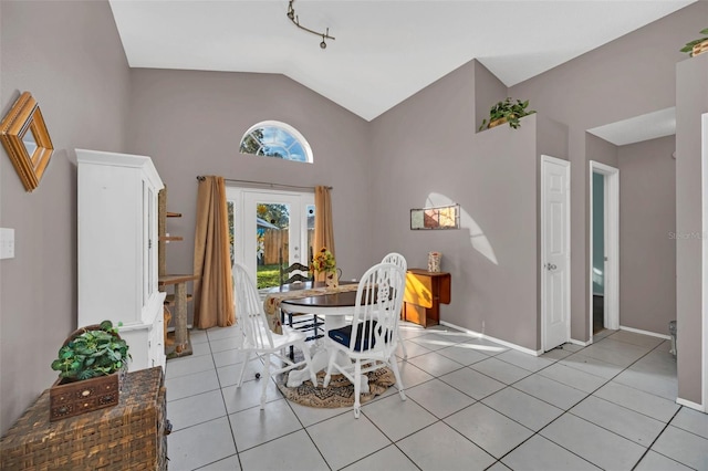 unfurnished dining area featuring light tile patterned flooring and lofted ceiling