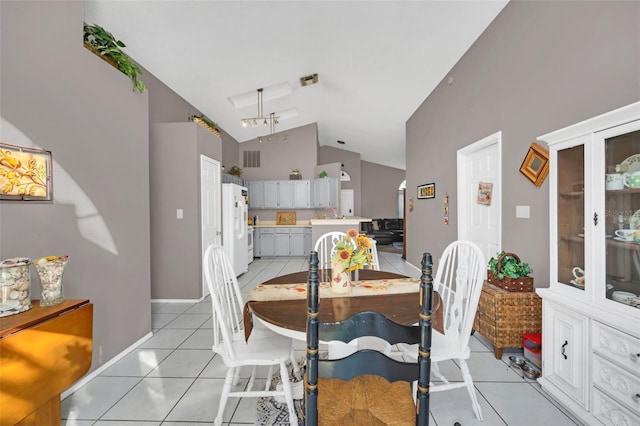 tiled dining room with vaulted ceiling