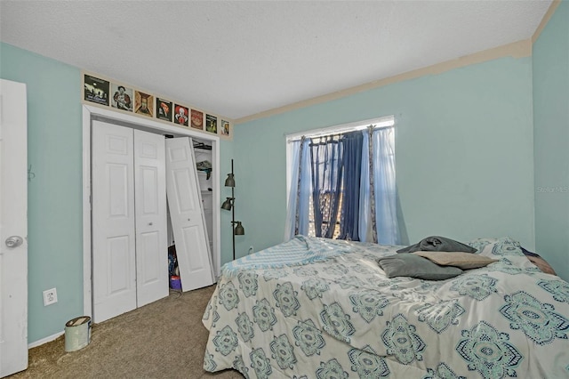 carpeted bedroom with a closet and a textured ceiling