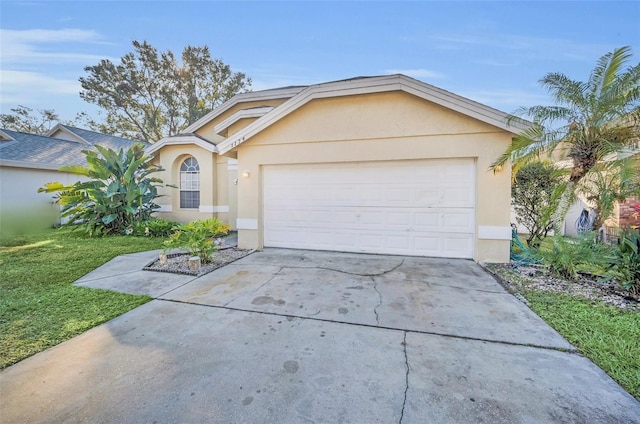 ranch-style home with a garage and a front lawn