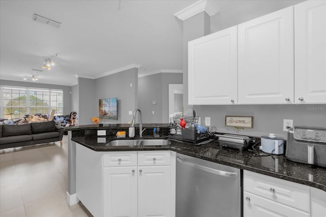 kitchen featuring dishwasher, white cabinets, dark stone countertops, and sink