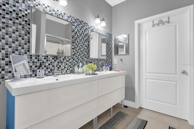 bathroom with vanity, tasteful backsplash, tile patterned floors, and a shower with door