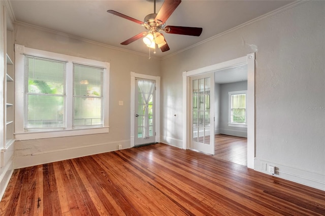 unfurnished room with ceiling fan, wood-type flooring, and ornamental molding