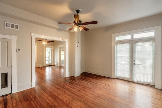 spare room with ceiling fan, hardwood / wood-style floors, and crown molding