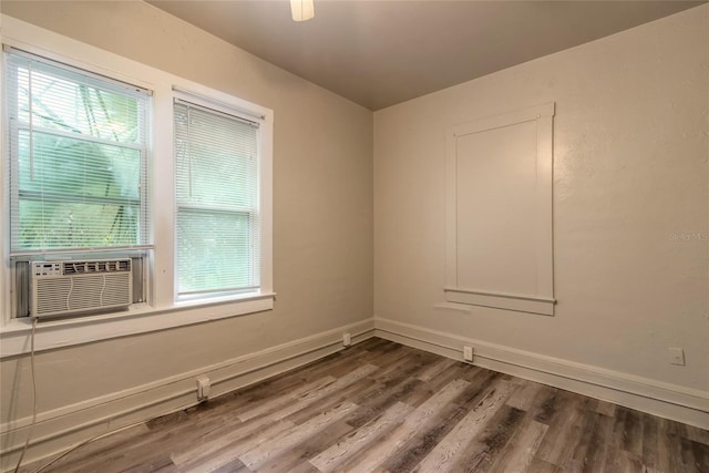 empty room with hardwood / wood-style flooring, a wealth of natural light, and cooling unit