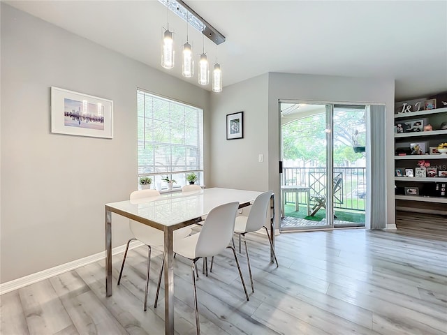 dining area featuring a notable chandelier and light hardwood / wood-style flooring