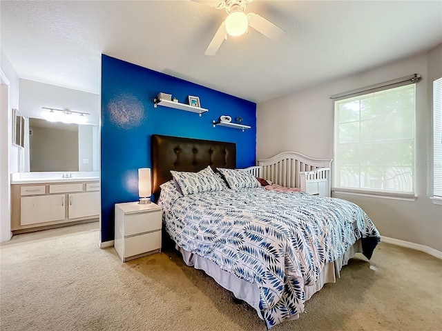 carpeted bedroom with connected bathroom and ceiling fan