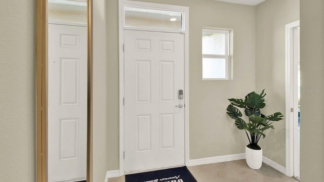 foyer entrance featuring light tile patterned floors