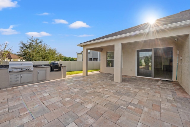 view of patio featuring exterior kitchen and grilling area