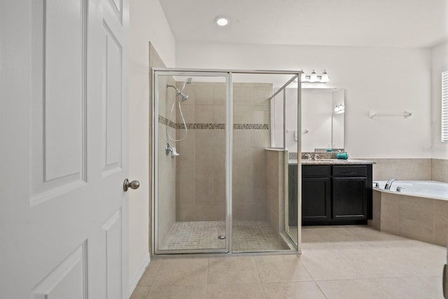 bathroom with tile patterned flooring, vanity, and shower with separate bathtub