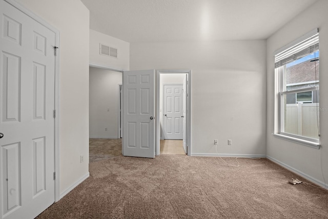 unfurnished bedroom featuring light colored carpet