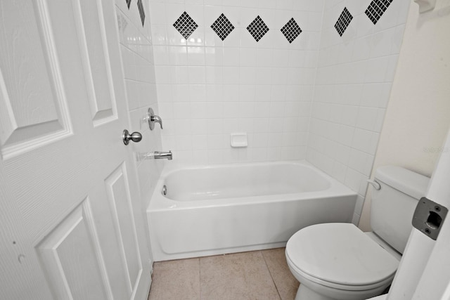 bathroom with tile patterned flooring, toilet, and bathtub / shower combination