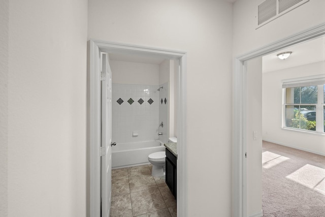 full bathroom with vanity, toilet, and tiled shower / bath combo