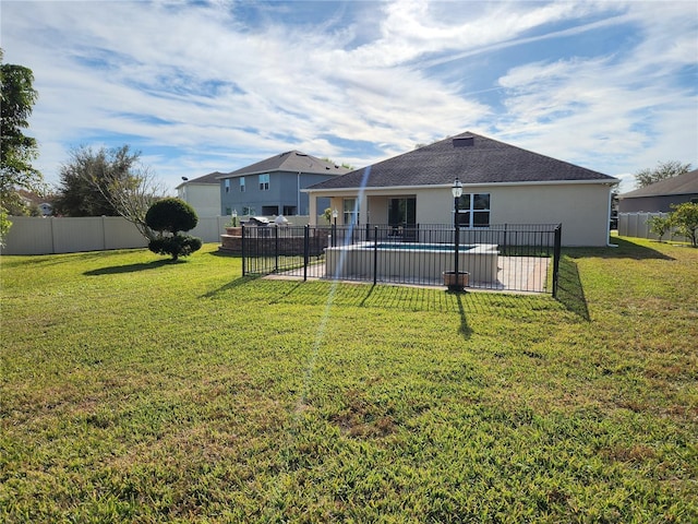 back of property featuring a yard, a fenced in pool, and a patio area