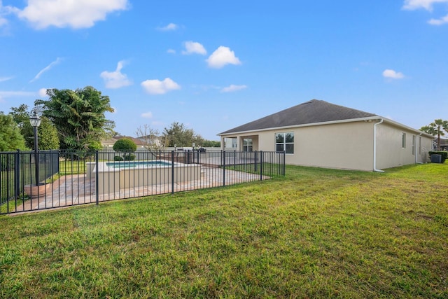 view of yard with a fenced in pool and a patio