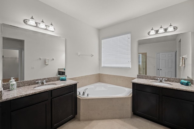 4032 Prairie Reserve Blvd, Orlando, FL 32824 - full bathroom featuring tile patterned flooring, a bath, a stall shower, two vanities, and a closet