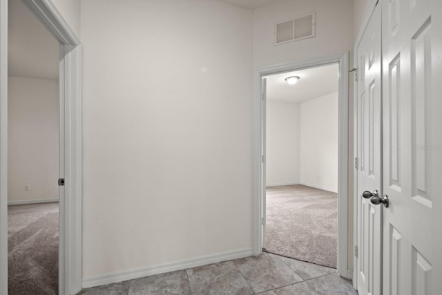 4032 Prairie Reserve Blvd, Orlando, FL 32824 - hall with light colored carpet, baseboards, and light tile patterned flooring
