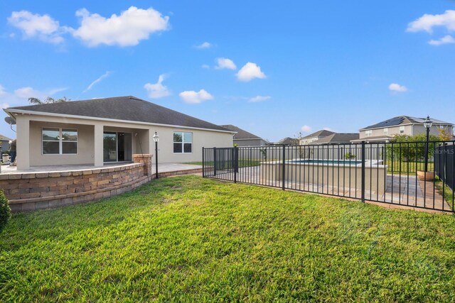 4032 Prairie Reserve Blvd, Orlando, FL 32824 - rear view of property featuring stucco siding, a patio area, and a residential view
