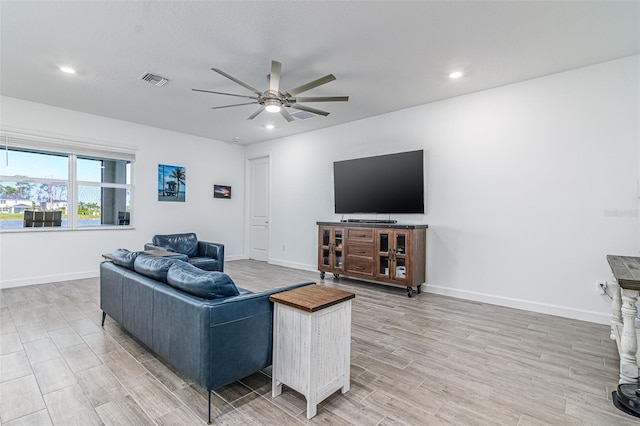 living room featuring ceiling fan and light wood-type flooring