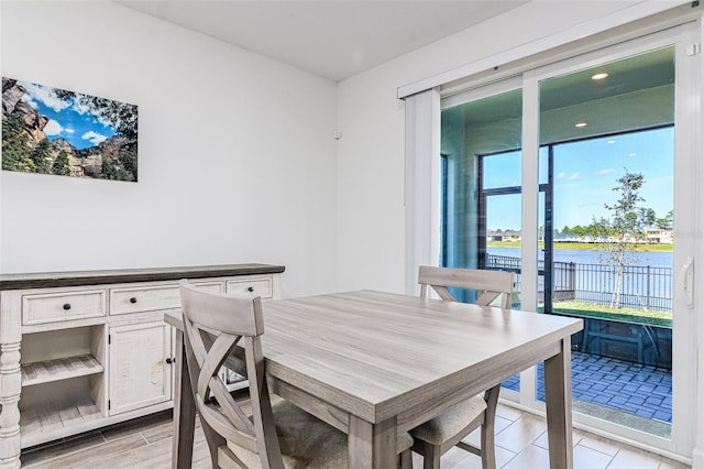 dining room featuring a water view