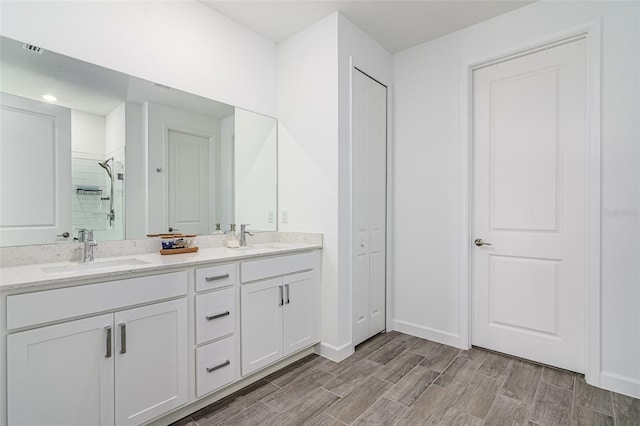 bathroom featuring walk in shower and vanity